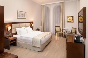 Un pat sau paturi într-o cameră la Concorde Old Bucharest Hotel