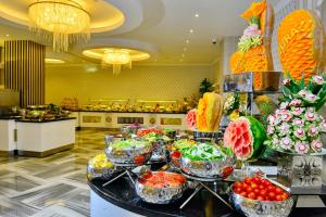 a buffet line with fruit and vegetables in a restaurant at Azura Deluxe Resort & Spa - Ultra All Inclusive in Avsallar
