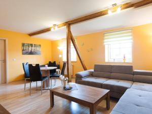 a living room with a couch and a table at Ferienwohnung Knoth in Altenburg