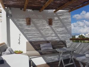 a living room with a couch and a table at My Rooms Ciutadella Adults Only by My Rooms Hotels in Ciutadella