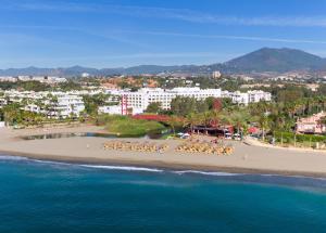 a beach scene with a large body of water at Melia Marbella Banús in Marbella