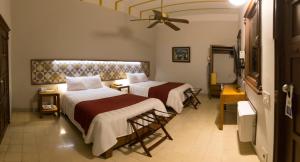 Postel nebo postele na pokoji v ubytování Hotel Caribe Merida Yucatan