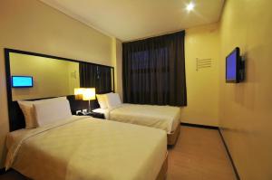Ein Bett oder Betten in einem Zimmer der Unterkunft Go Hotels Puerto Princesa