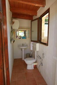 a bathroom with a toilet and a sink at Villa Giulia in Castellammare del Golfo