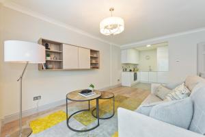 a living room with a couch and a table at Exclusive City Centre Apartment in Dublin