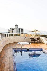 a swimming pool on the roof of a building at Blue Hill Hotel in Timbó