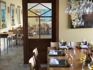 a dining room with a table with wine glasses at Fischerklause am Lutjensee Hotel Garni in Lütjensee +24 photos