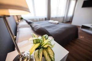 a bed with a flower arrangement on top of it at Apartamenty Baszta in Gdańsk