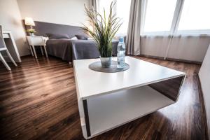 a white coffee table with a bottle of water on it at Apartamenty Baszta in Gdańsk