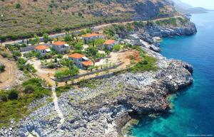 an aerial view of a home on a rocky coast at Katafigio Holiday Homes in Riglia