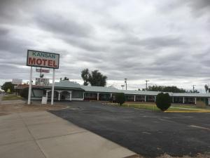 a motel with a sign in front of a building at Kansan Motel in Liberal +11 photos