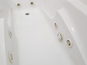 a white bathtub with silver fixtures on a white wall at Vila Régia in Funchal +33 photos