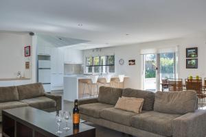 a living room with a couch and a table at Portsea Place in Portsea