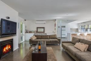a living room with a couch and a fireplace at Portsea Place in Portsea