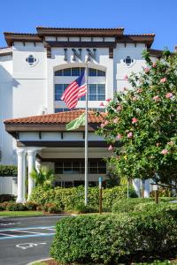 an american flag flying in front of a building at Inn at Pelican Bay in Naples