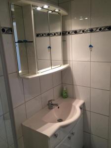 a white bathroom with a sink and a mirror at Laboe-Hafen in Laboe