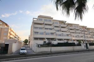 Un edificio blanco con un coche aparcado delante. en Sea view Penthouse Denia, ELEGANCE, en Denia 70 fotos más
