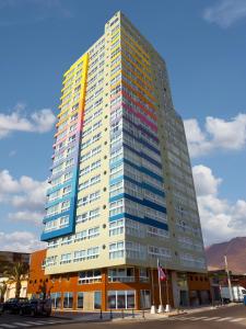 a tall office building with a rainbow at Gran Cavancha Hotel & Apartment in Iquique
