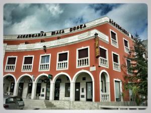 a red building with a sign on top of it at Albergaria Malaposta in Pegões