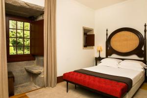 Cama ou camas em um quarto em Pousada Mosteiro de Guimaraes