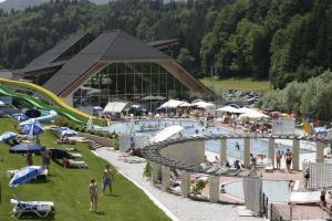 a large swimming pool with people at a resort at Apartmaji Hribar Pr'Ostank in Kamnik