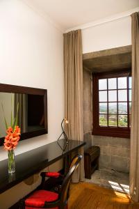 Cama ou camas em um quarto em Pousada Mosteiro de Guimaraes