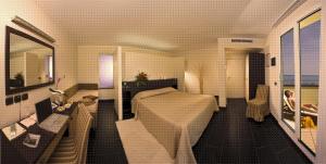 a rendering of a hotel room with a bed and a desk at Hotel Cavalluccio Marino in Gabicce Mare