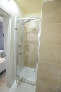 a shower with a glass door in a bathroom at Arianna in Salerno