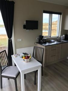 a kitchen with a table with a bowl of fruit on it at Helgafell in Stykkishólmur