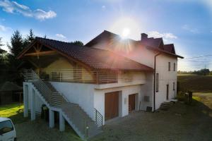 a house with a roof with a staircase on it at Harmony Hostel in Zator