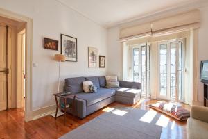 a living room with a couch and a tv at Charming Apartment Marquês in Lisbon