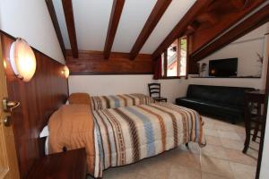 מיטה או מיטות בחדר ב-Albergo Santo Spirito