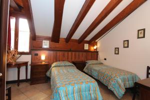 A bed or beds in a room at Albergo Santo Spirito