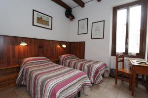 A bed or beds in a room at Albergo Santo Spirito