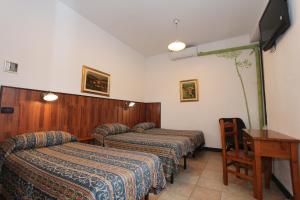 A bed or beds in a room at Albergo Santo Spirito