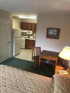 a living room with a table and a kitchen at Affordable Suites Conover / Hickory in Conover