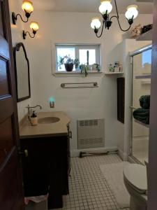 a bathroom with a sink and a toilet and a window at JUNE Summer Sale NANTASKET Beach in Hull