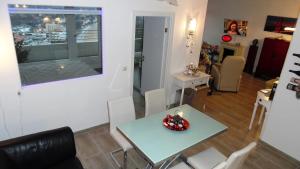 a dining room and living room with a table and chairs at Luxussuite 1A Meerblick, Maritim Residenz, 22er Stock, modernes Styling, am Strand in Travemünde