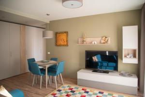 a living room with a table and a television at Apartment Cristian 2 in Timişoara