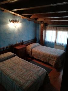 Postel nebo postele na pokoji v ubytování Casa Rural La Muralla