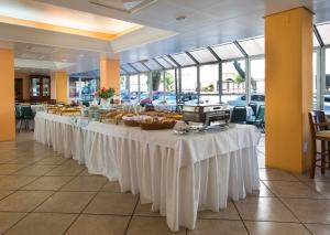 a buffet line of tables with food on them at Marina´s Palace Hotel in Florianópolis