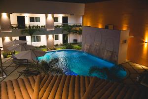 a swimming pool in the middle of a building with umbrellas at Luxury Hotel Inn in La Peñita de Jaltemba