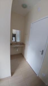 a room with a bathroom with a sink and a mirror at Pousada Maré Enseada in Guarujá