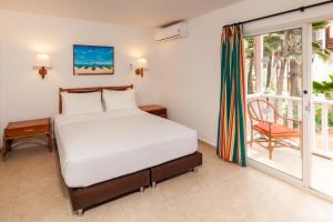Ένα ή περισσότερα κρεβάτια σε δωμάτιο στο Decameron San Luis - All Inclusive