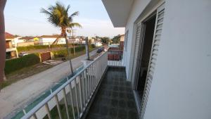 a balcony of a house with a view of a street at Pousada Maré Enseada in Guarujá