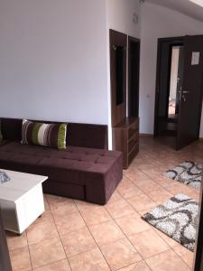 a living room with a couch and a coffee table at Pensiunea Zbor 1 in Cluj-Napoca
