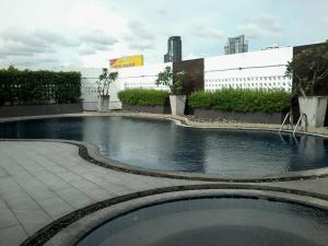 a swimming pool in the middle of a building at Nice view over the heart of Bangkok in Bangkok