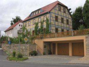 a large house with a large garage in front of it at In der alten Weinstube in Freital
