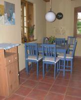 a dining room with blue chairs and a table at In der alten Weinstube in Freital