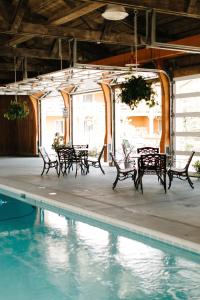 a pool with benches next to a swimming pool at Brown County Inn in Nashville